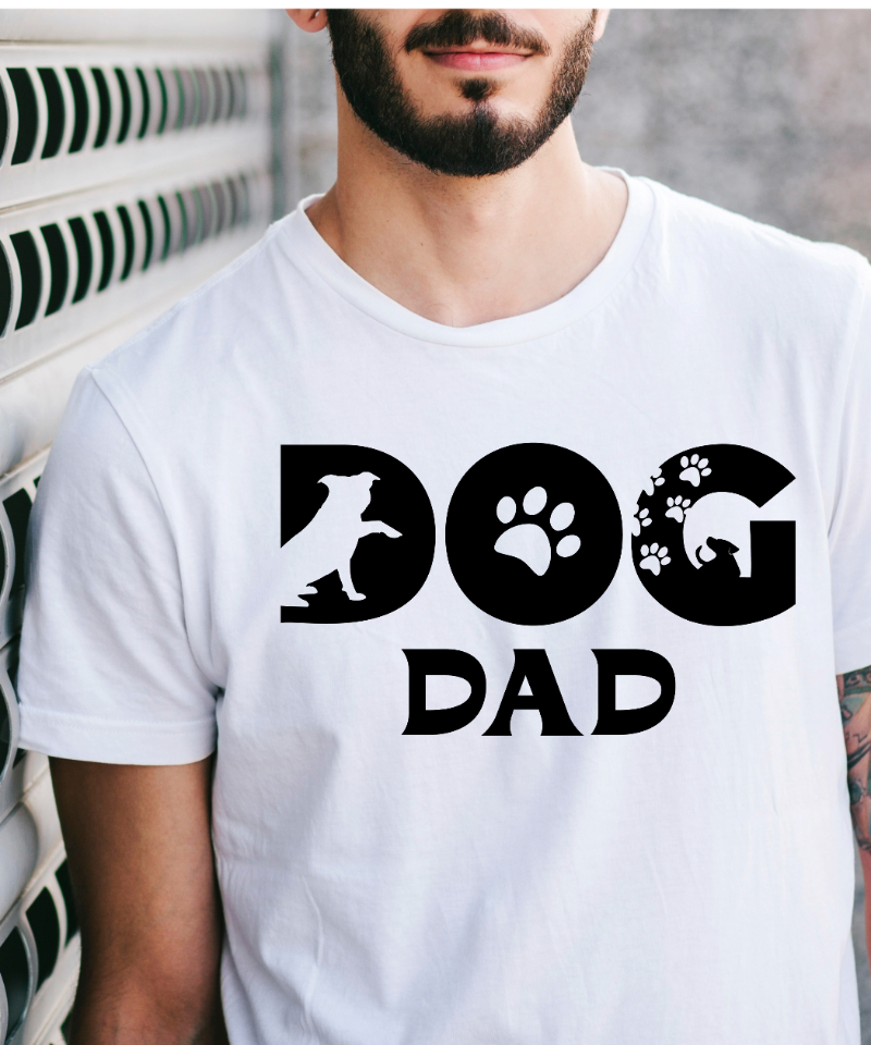 Man wearing a white t-shirt with 'DOG DAD' text and dog paw prints.