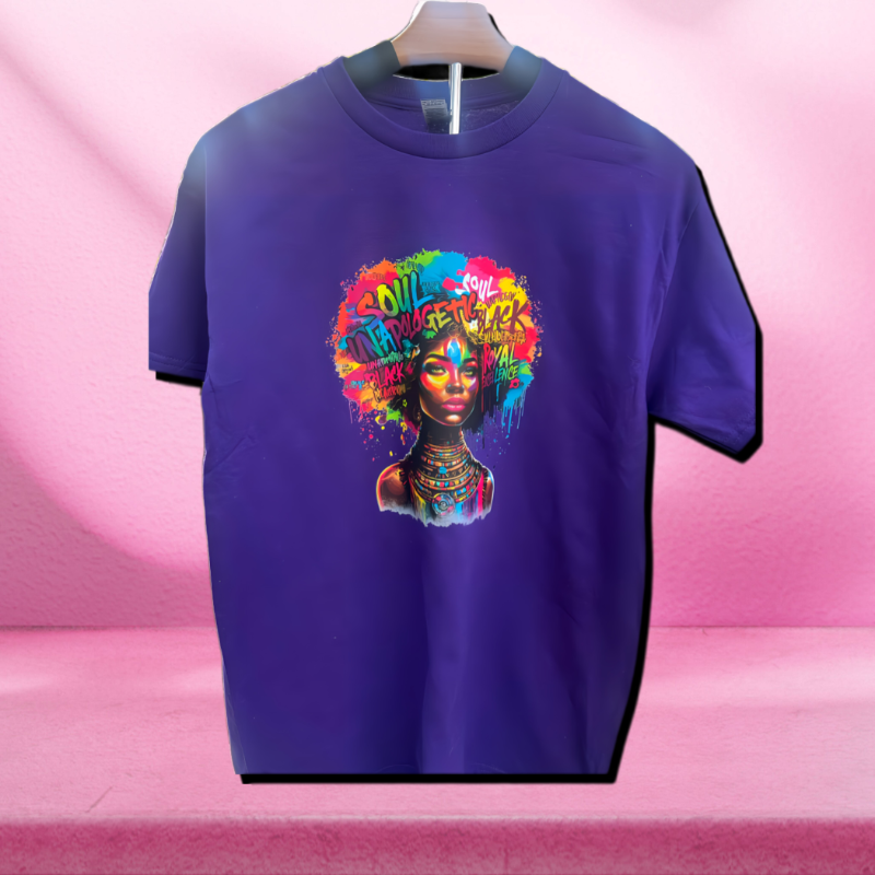 A purple t-shirt featuring a graphic print of a Black woman with an afro, surrounded by colorful abstract designs and text.