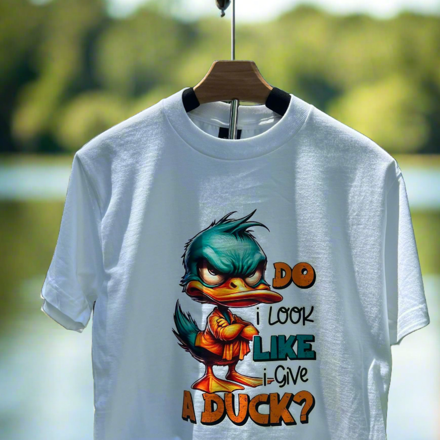 A white t-shirt with a graphic print of a duck and the text phrase 'DO I LOOK LIKE A DUCK?', indicating a humorous and bold-colored design.