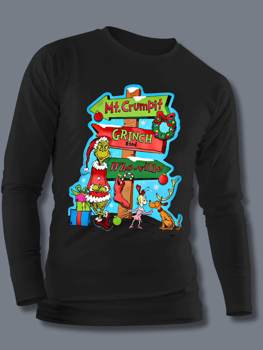 A black-colored t-shirt with a graphic design featuring the character 'The Grinch' and a whimsical road sign pointing to Mt. Crumpit and Whoville.