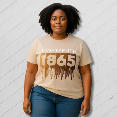 Woman wearing a t-shirt with 'Juneteenth 1865' design on a sidewalk.