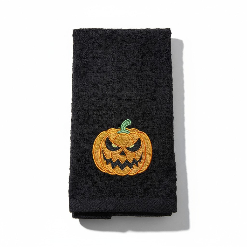 Black towel with a jack-o'-lantern design on a white background