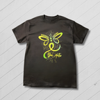 Black t-shirt with a green butterfly design on a wooden surface with a yellow flower field background