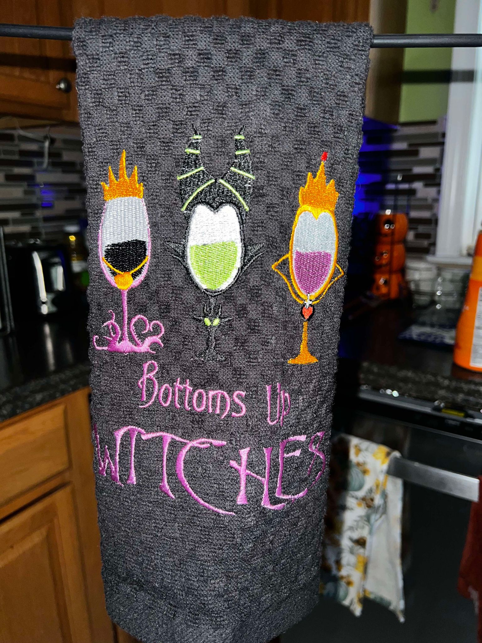 Black towel with three wine glasses Halloween themed that says Bottoms Up Witches