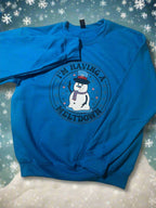Blue sweatshirt with melting snowman graphic and the phrase “I’m Having a Meltdown”