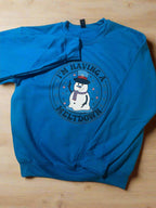 Humorous holiday sweatshirt with snowman illustration and playful text