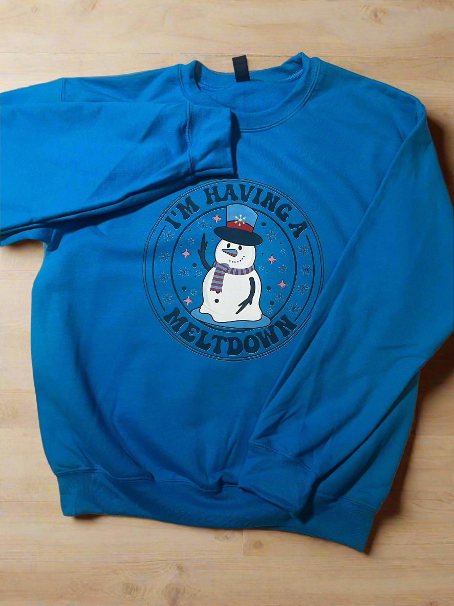 Humorous holiday sweatshirt with snowman illustration and playful text