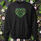 Black sweatshirt with a green floral heart design on a dark background with flowers and leaves.