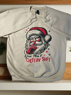 Novelty Christmas sweatshirt with Santa illustration and sassy text, perfect gag gift