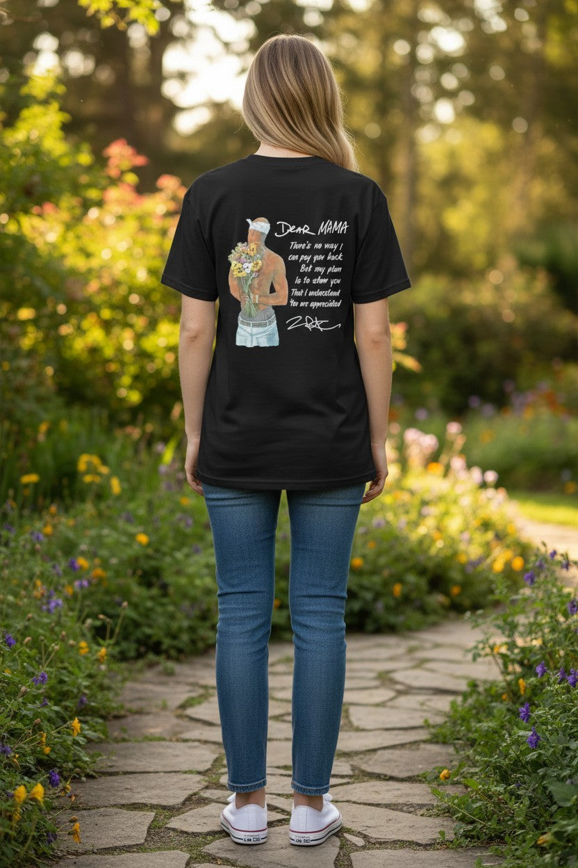 Person wearing a black t-shirt with a graphic design in a garden setting