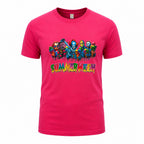 A bright pink short-sleeve crewneck t-shirt featuring a colorful graphic of cartoon superheroes and the word 'SUMMERWEEN' in a dripping multicolor font across the chest.