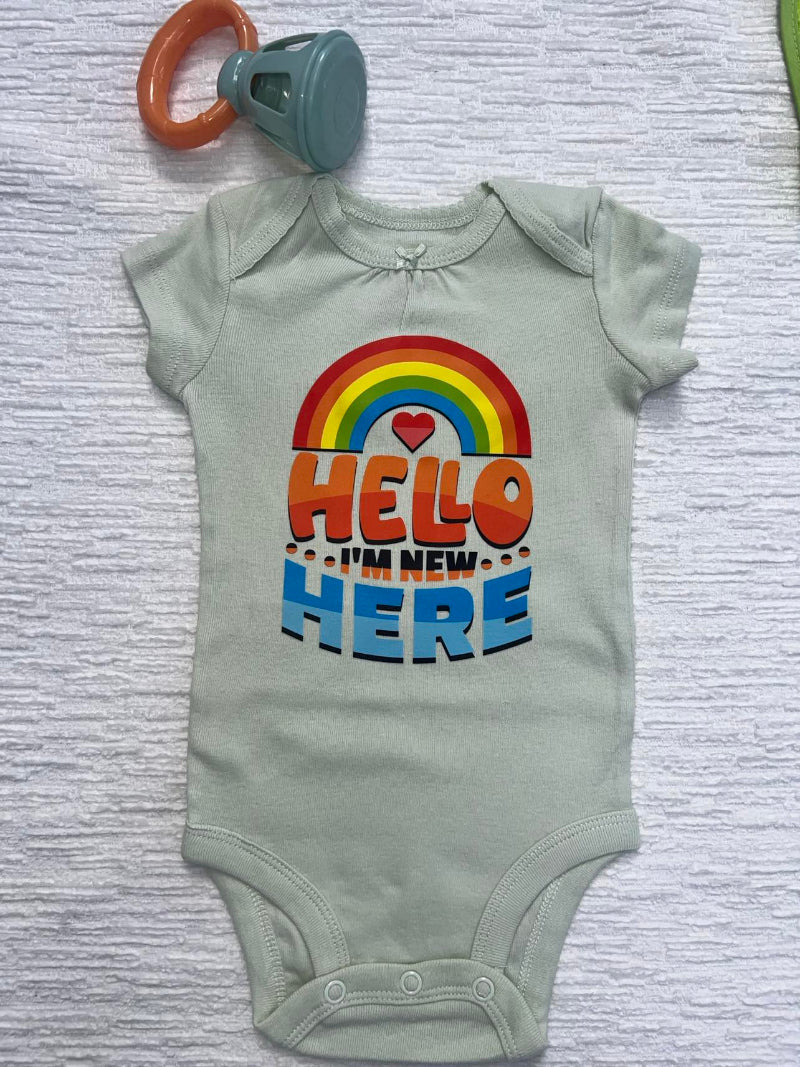 Olive gree baby onesie with a graphic that says: "Hello I'm New Here" written under a rainbow.