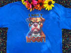 A Blue graphic t-shirt with a dog face and the words "I Don't Give A Woof" on a colorful background with flowers near the collar of shirt.