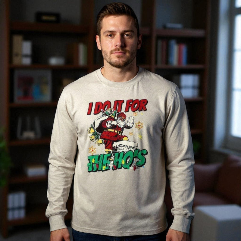 Man wearing a long-sleeve shirt with a graphic design in a room with bookshelves.