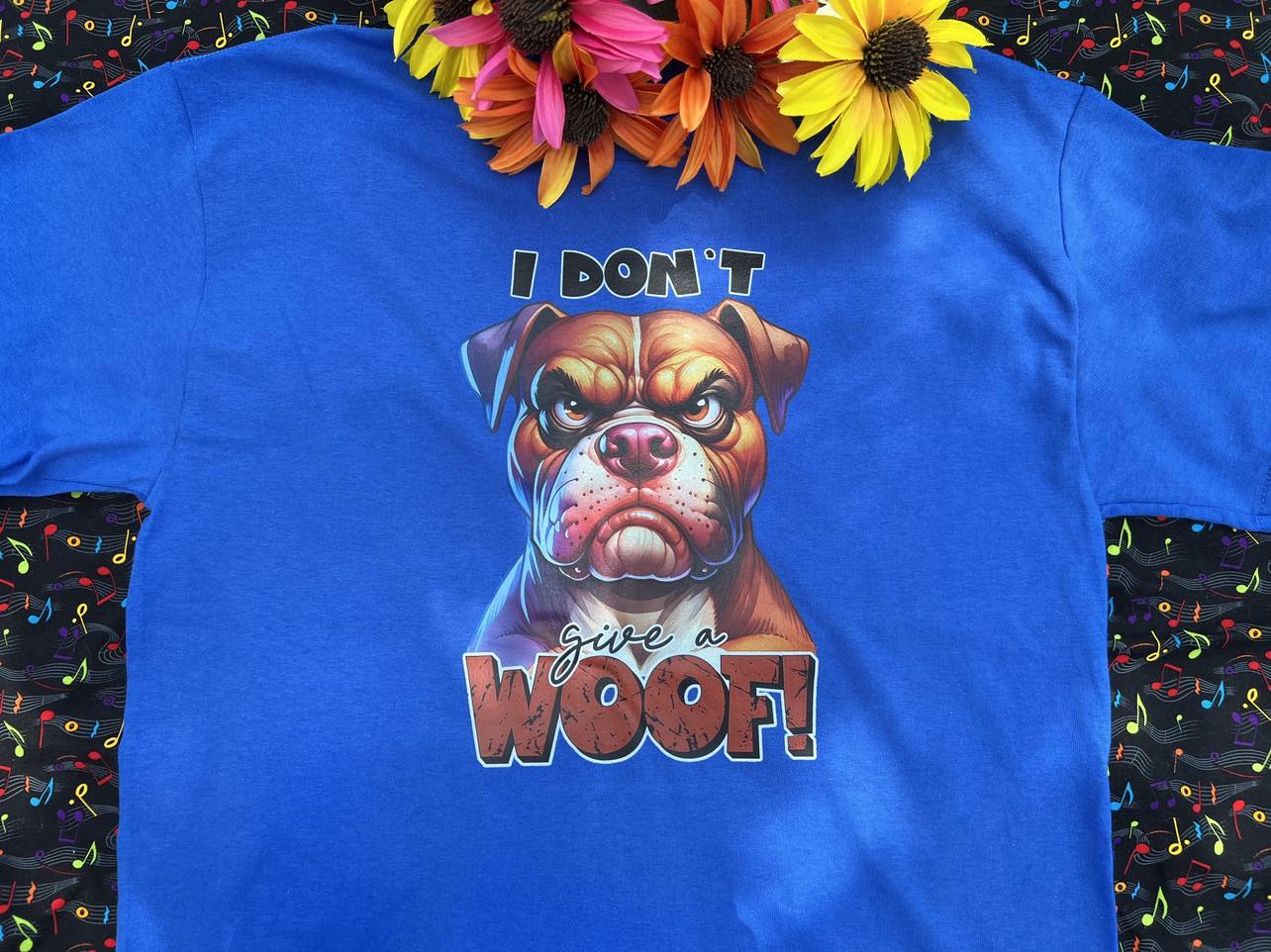 A Blue graphic tshirt with a dog face and the words "I Don't Give A Woof"