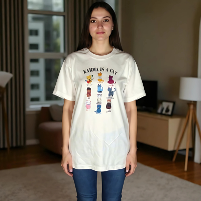 Woman wearing white Karma Is A Cat Taylor Swift lyric tee styled casually.