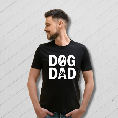 Man wearing a black 'DOG DAD' t-shirt on a yellow background