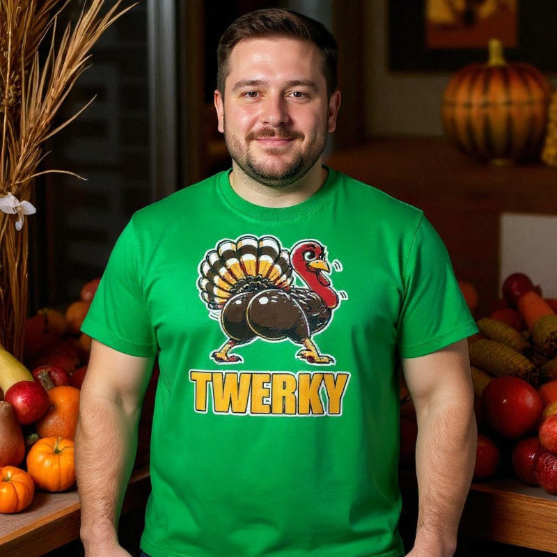 Man wearing a green t-shirt with a turkey graphic and 'Twerky' text, standing in front of a festive background with pumpkins and apples.