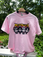 A pink graphic tee shirt featuring a black and white design of cat faces with the text 'MEOWTALLIA' in bold letters.