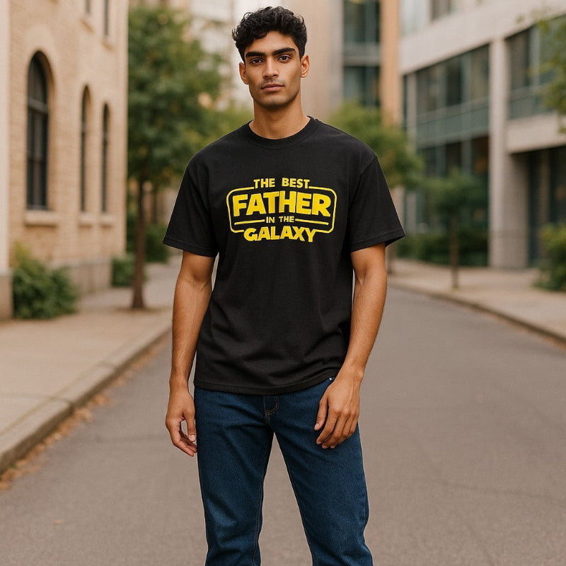 Model wearing a black t-shirt with yellow text on a city street background.