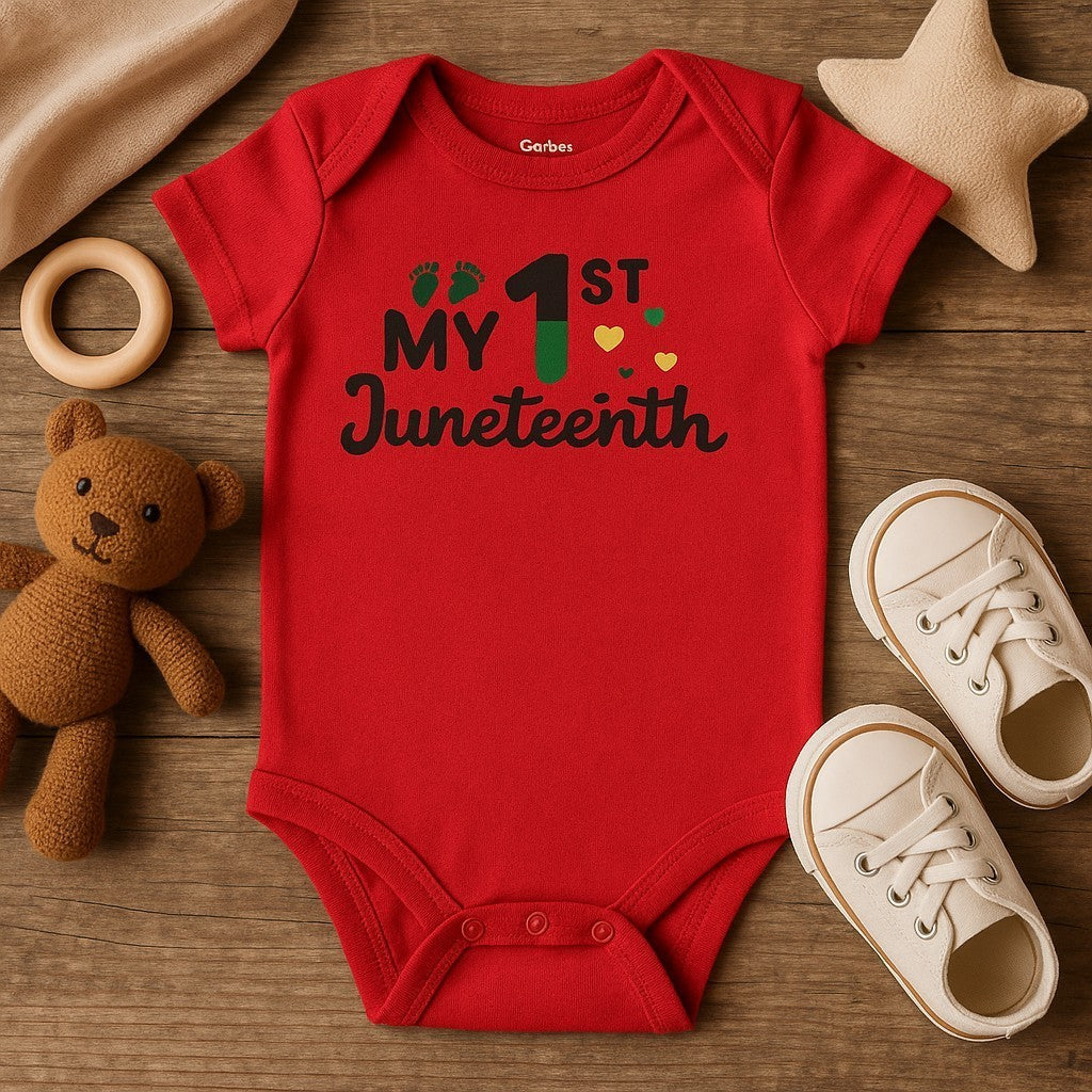 Red baby onesie with 'My 1st Juneteenth' text on a wooden surface with toys.