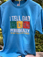 Chemistry-themed nerdy dad jokes graphic shirt on stand outdoors.