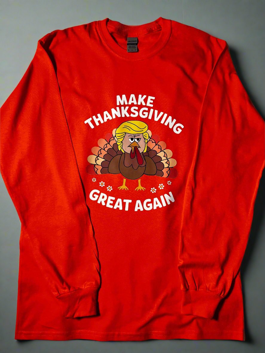 An orange t-shirt with a graphic of a turkey and the text 'Make Thanksgiving Great Again' printed on the front.