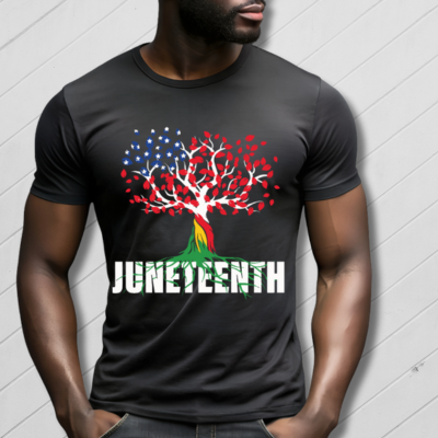 Person wearing a black t-shirt with a colorful tree design and 'JUNETEENTH' text on a gray background