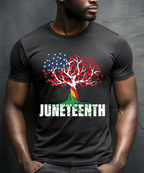 Person wearing a black t-shirt with a Juneteenth design featuring a tree with red and blue leaves on a gray background.