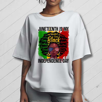 Person wearing a white t-shirt with Juneteenth design featuring text and a graphic of a woman.