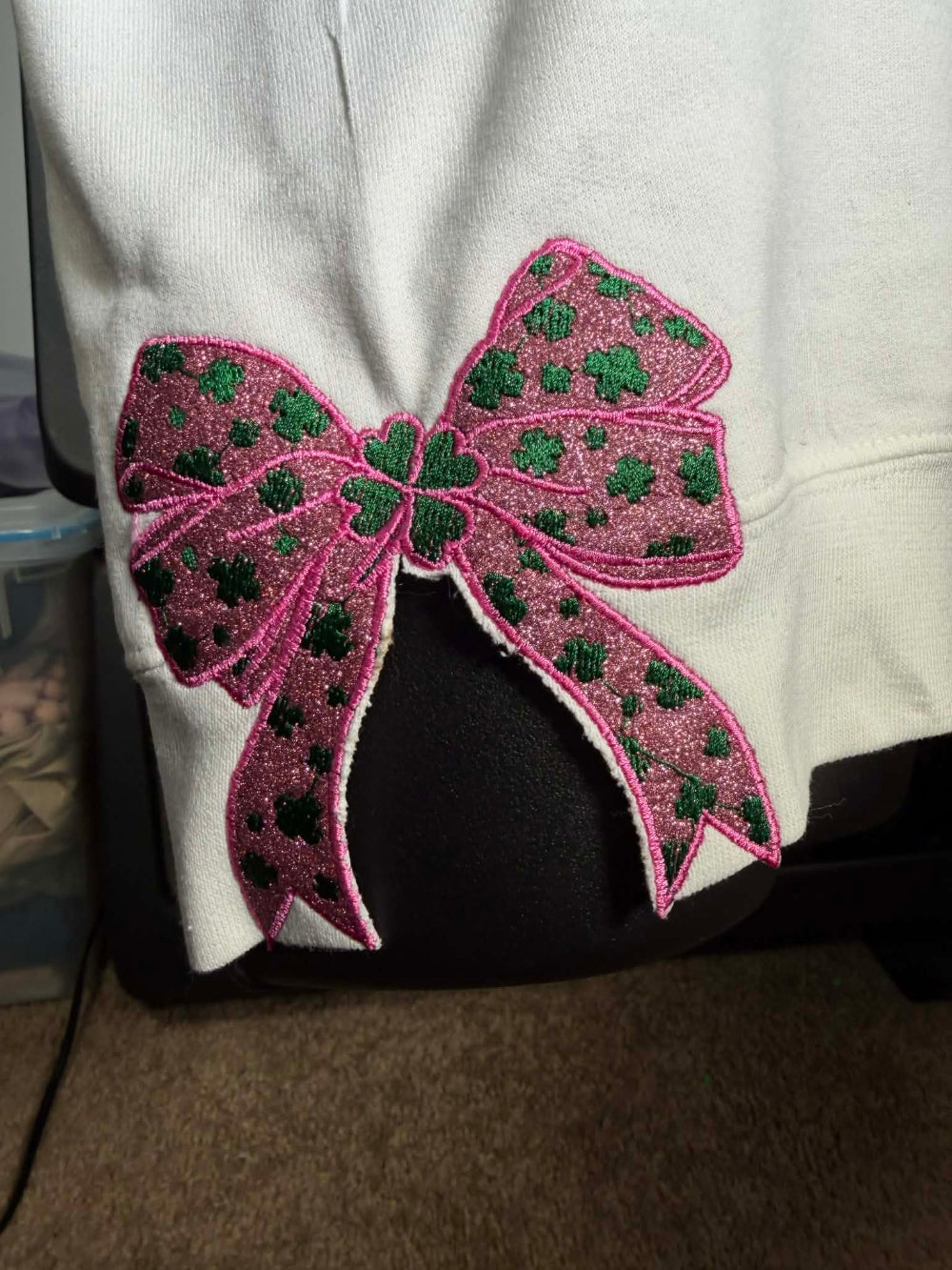 Pink bow with green accents on a white background