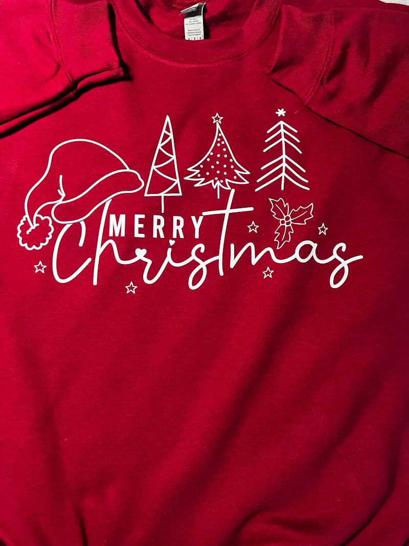 Close up of a red sweatshirt with 'Merry Christmas' text and a graphic of a Santa hat and Christmas trees on it.