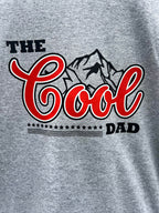 Close up of The Cool Dad graphic on a grey shirt.