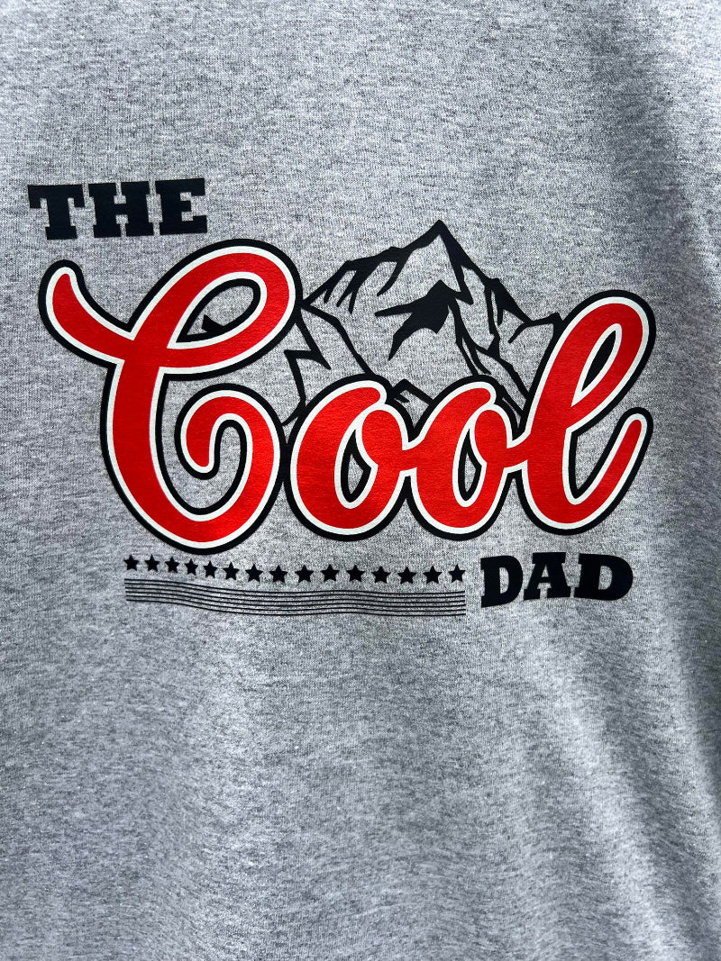 Close up of The Cool Dad graphic on a grey shirt.