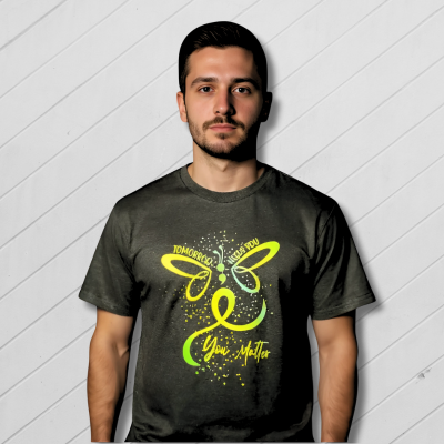 Man wearing a dark gray t-shirt with a green butterfly design and text in a living room.