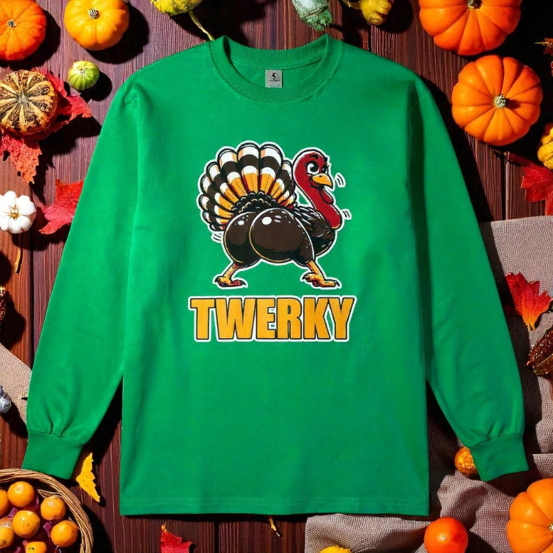 Green sweatshirt with a turkey graphic and 'TWERKY' text on a wooden background with pumpkins and leaves.