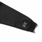 Black sleeve with text embroidery on a white background