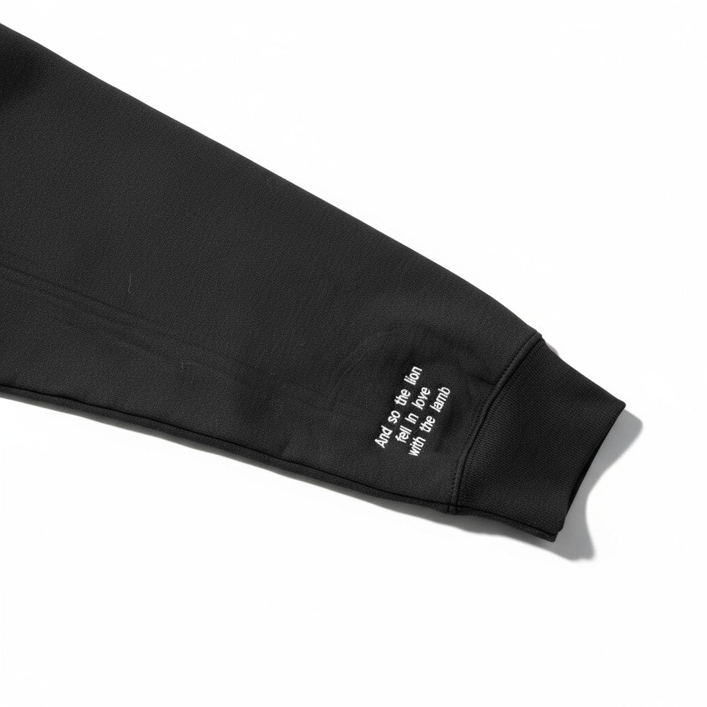 Black sleeve with text embroidery on a white background