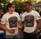 Two men wearing matching white graphic t-shirts with a distressed black and red eagle design that reads 'I'M ACTUALLY THE FORTUNATE SON' and 'AMERICA 250'. The photo is taken at an outdoor evening gathering with people and string lights in the background.