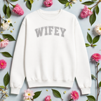 White sweatshirt with 'WIFEY' text on a light blue background with flowers and leaves.
