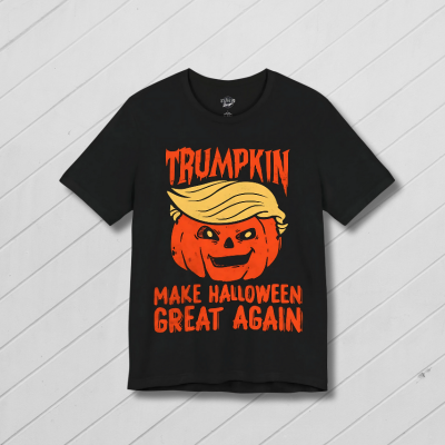 Black t-shirt with a pumpkin and text design on a white wooden background