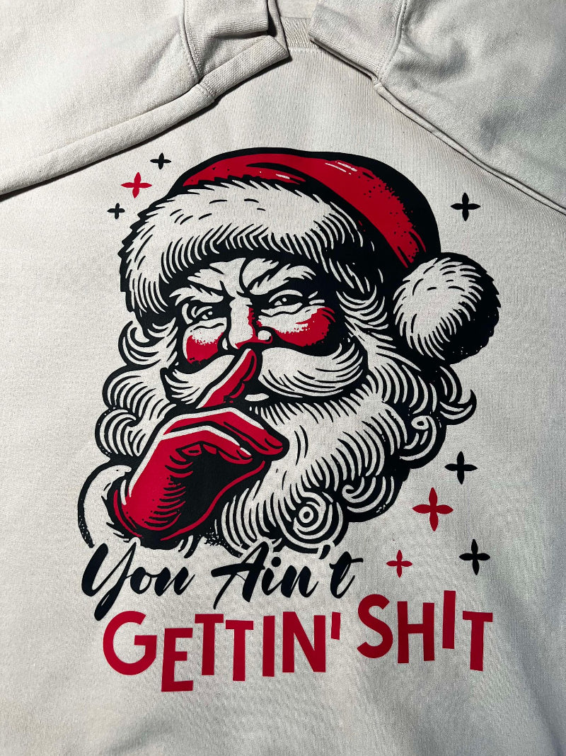 close up of a sarcastic Christmas sweatshirt featuring vintage Santa illustration and humorous text