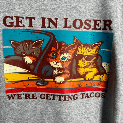 Close-up of TacoCats retro print with cats driving car to get tacos.