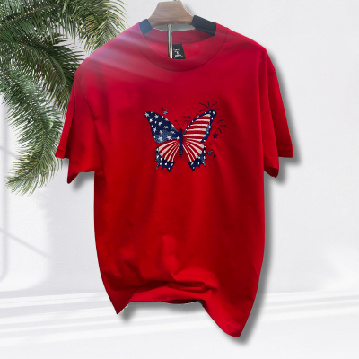 Actual product on stand. Red t-shirt with embroidered patriotic butterfly on front.