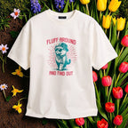 White t-shirt with a graphic design of a bear wearing a hat and scarf, surrounded by flowers.