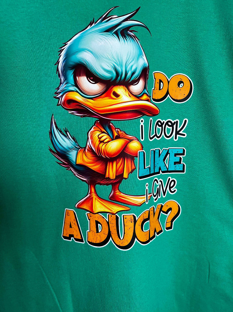 Close-up of duck cartoon with folded arms on Do I Look Like I Give a Duck on green shirt.