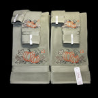 Set of green towels with pumpkin designs on a black background