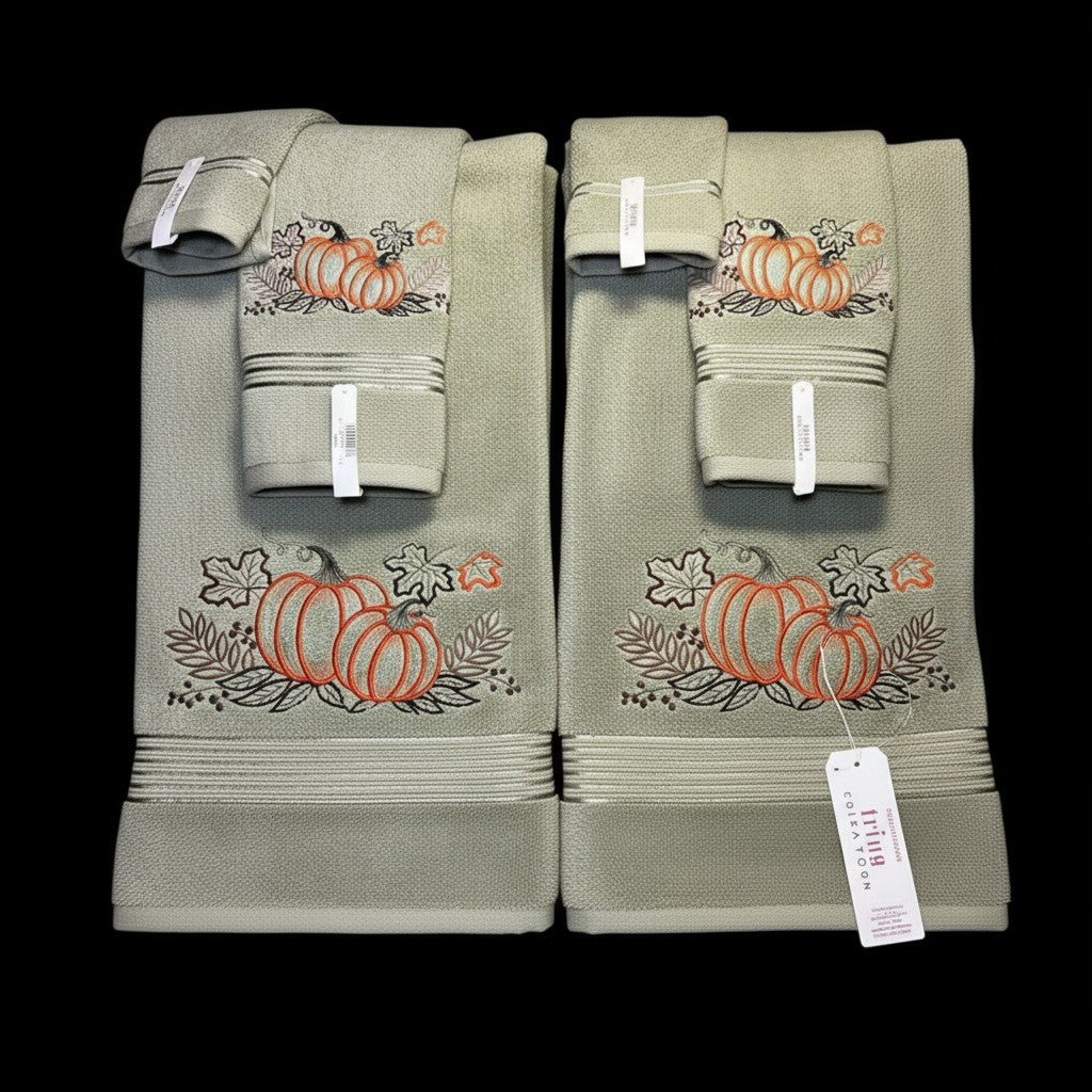 Set of green towels with pumpkin designs on a black background
