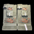Set of green towels with pumpkin designs on a black background