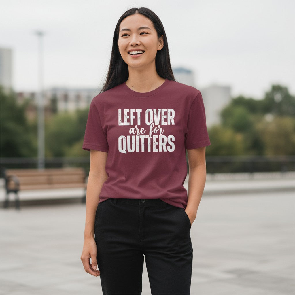 Person wearing a maroon t-shirt with text outdoors